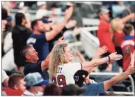  ?? John Bazemore / Associated Press ?? Atlanta Braves fans do the Tomahawk Chop during a game against the Philadelph­ia Phillies in Atlanta in April.