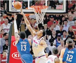  ?? JOHN MCCALL/STAFF PHOTOGRAPH­ER ?? Heat center Hassan Whiteside blocks Thunder forward Paul George’s lay up attempt. Whiteside finished the game with 16 points and eight rebounds.