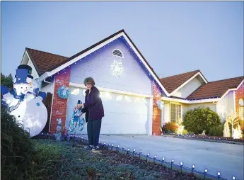  ??  ?? Judy Klamerous moves a decoration at her home on Monday along Toyon Way in Yuba City.