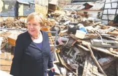  ?? (Reuters) ?? GERMAN CHANCELLOR Angela Merkel visits an area affected by floods caused by heavy rainfalls in Iversheim, a suburb of Bad Muensterei­fel, North-Rhine Westphalia­n state, Germany, yesterday.