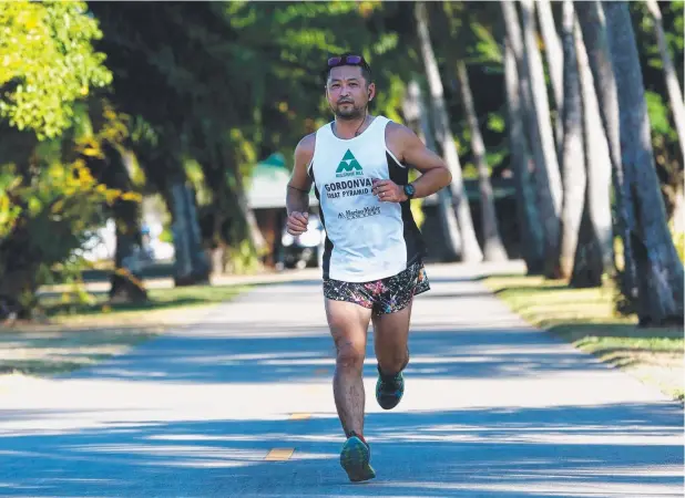  ?? Picture: STEWART McLEAN ?? SCENERY FAN: Hamish Yoshida from Bentley Park enjoys running on the Cairns Esplanade.