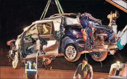  ?? TOM KELLY III — DIGITAL FIRST MEDIA ?? Berks-Mont Towing workers use a crane to remove this vehicle from a ravine along Route 100 near Farmington Avenue in Upper Pottsgrove Township Wednesday evening. The southbound vehicle left the roadway for an unknown reason just after it passed under...