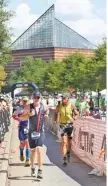  ?? STAFF PHOTO BY DAN HENRY ?? Chip Walters, front, from Harrison, Tenn., and others leave the biketo-run transition during the Little Debbie Ironman Chattanoog­a triathlon on Sunday. Athletes endured hot conditions to race.