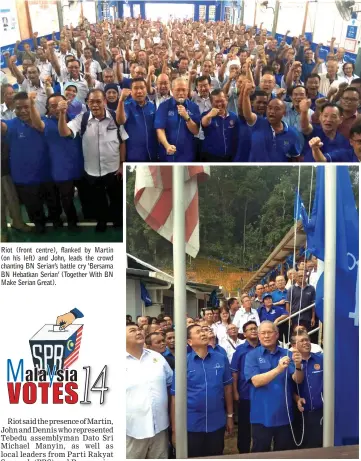  ??  ?? Riot (front centre), flanked by Martin (on his left) and John, leads the crowd chanting BN Serian’s battle cry ‘Bersama BN Hebatkan Serian’ (Together With BN Make Serian Great). Riot raises the BN flag to launch the Serian BN GE14 Ops Centre as others...