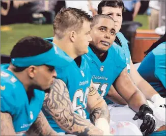  ?? Bill Feig Associated Press ?? AGAINST THE SAINTS in September, Richie Incognito, second from left, sits next to Jonathan Martin, third from left. Quarterbac­k Ryan Tannehill says he believed they were best friends.