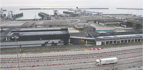  ?? STIN TALLIS/AFP VIA GETTY IMAGES ?? A truck drives in the port of Dover, Britain's trade gateway to the EU, in southeast England on Jan. 1. Fearing chaos at the border from Brexit red tape, many companies are delaying deliveries or stockpilin­g goods.