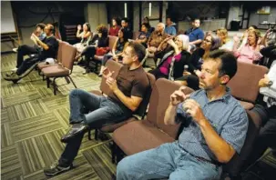  ?? CRAIG KOHLRUSS/FRESNO BEE/TRIBUNE NEWS SERVICE ?? Congregati­on members sign during a worship song at a service with Fresno Deaf Church held at The Bridge Fresno.