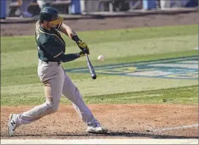  ?? Ashley Landis / Associated Press ?? Oakland’s Chad Pinder hits a tying three-run homer in the seventh inning against Houston before Sean Murphy’s go-ahead sac fly in the eighth.