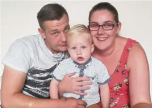  ??  ?? ●● Gareth and Stacey with their son Archie who was taken to hospital after apparently eating cannabis found on the ground outside his home