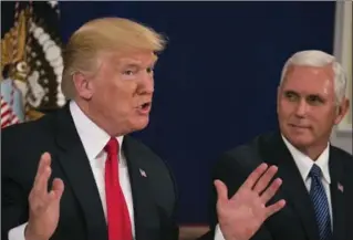  ?? AL DRAGO, NEW YORK TIMES ?? President Donald Trump speaks to reporters, as Vice-President Mike Pence looks on Thursday.