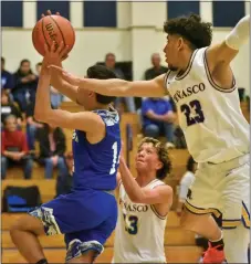  ?? ?? Marcus Gonzales finishes the tough layup between Jeremiah Martinez, far right, and Donnivan Aguilar.