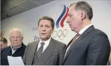  ?? PAVEL GOLOVKIN THE ASSOCIATED PRESS ?? Russian Olympic Committee president Alexander Zhukov, centre, thanked athletes and fans following the announceme­nt.