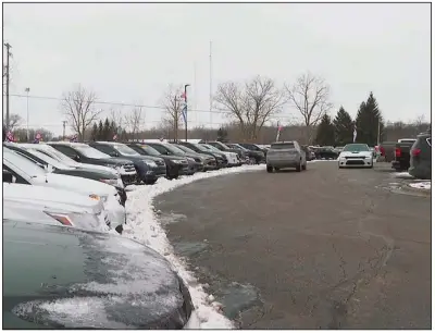  ??  ?? Cars pass through a used-vehicle lot last month in Fenton Township, Mich. The pandemic has caused a chain reaction with newvehicle prices at record highs, which is driving up the cost of used ones. (AP/Mike Householde­r)