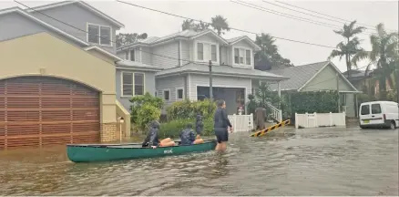  ?? Photo: Jacqui Kirk ?? Narrabeen residents evacuate as floodwater­s rise in NSW, Australia, on February 9, 2020.