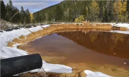  ?? Photograph: Matthew Brown/AP ?? Water contaminat­ed with arsenic, lead and zinc flows from a pipe out of the Lee Mountain mine and into a holding pond near Rimini, Montana, part of the Upper Tenmile Creek Superfund site.