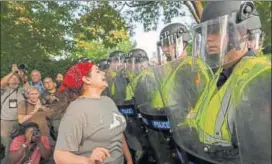  ?? AP ?? Police face off with students on the grounds of the University of Virginia in Charlottes­ville on Saturday.