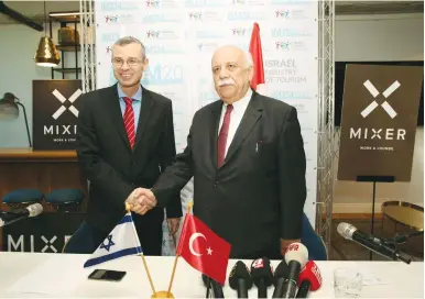  ?? (Chen Galil) ?? TOURISM MINISTER Yariv Levin (left) shakes hands with Turkish Culture and Tourism Minister Nabi Avci, at the opening of the Internatio­nal Mediterran­ean Tourism Market in Tel Aviv yesterday.