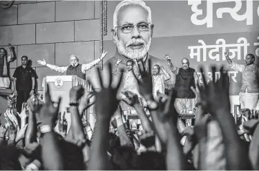  ?? Atul Loke / Getty Images ?? Narendra Modi speaks to victorious party workers at his party’s headquarte­rs in New Delhi, India, on Thursday after he won another five-year term as prime minister.