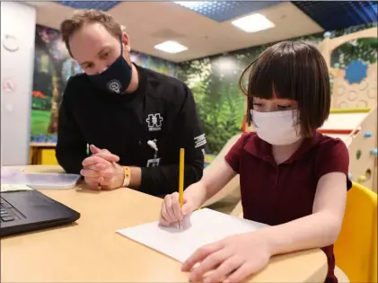  ?? K.M. Cannon Las Vegas Review-journal @Kmcannonph­oto ?? Akara Haase, 6, works with behavior analyst Adam Volker on Wednesday at the Center for Autism and Developmen­tal Disabiliti­es at Touro University Nevada in Henderson. Touro’s autism center opened in 2008.