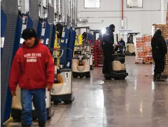  ?? Mark Mulligan / Houston Chronicle ?? Pallets of goods are loaded and unloaded in the dock area at Preferred Freezer’s 10-millioncub­ic-foot cold storage facility in Pasadena. The loading dock is kept just above freezing before products are placed in the storage area, which is cooled to...