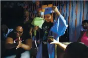  ?? JESSIE WARDARSKI — THE ASSOCIATED PRESS ?? Sharawn Vinson, front left, family members and friends cheer for her daughter, Maddison, as they watch her virtual graduation from middle school in the living room of their three-bedroom apartment in the Brooklyn.