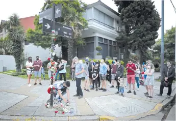  ?? AFP photo ?? Fans of late Maradona gather at the corner of his former home to pay tribute in Villa Devoto, Buenos Aires city. -