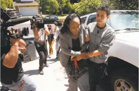  ?? Michael Macor / The Chronicle ?? Ina Rogers, the mother of 10 children who were allegedly tortured, is escorted to the front door of her Fairfield home, which police said was squalid.