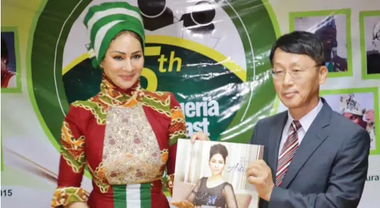  ??  ?? Director-General of NTDC, Dr. Sally Mbanefo presenting her book to the Director KCCN, Mr. Kwon Yong IK at the 5th Korea-Nigeria Poetry Feast