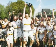  ?? ?? Going up: Esher captain Adam Bullett lifts the title