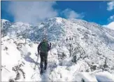  ?? ANDY LEWICKY ?? A SKIER climbs to the summit of Mt. Lukens, a 5,000-foot peak at the city’s northeast border.