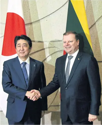  ?? AFP ?? Japan’s Prime Minister Shinzo Abe, left, greets Lithuanian counterpar­t Saulius Skvernelis in Vilnius on Saturday.