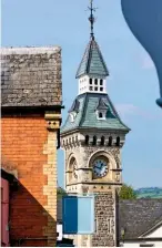  ??  ?? The impressive town clock topped by a slate roof and weathervan­e (near right). The 16th century, Grade II listed Three Tuns pub, the town’s oldest surviving hostelry (far right).