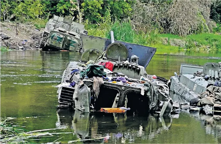  ?? ?? Clockwise from below: armoured fighting vehicles abandoned by fleeing invaders; Russian grenade launchers left abandoned; a Ukrainian soldier’s gesture of triumph