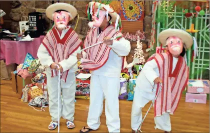  ?? / Doug Walker ?? A dance of the old men at the Feast of the Three Kings on Saturday features Emir Morillon (from left), Yarimir Martinez and Amar Segura.