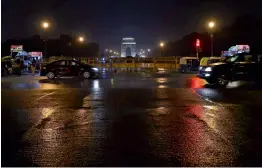  ??  ?? Vehicles ply on Rajpath during light showers on Monday evening.