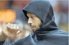  ?? MICHAEL LAUGHLIN/STAFF PHOTOGRAPH­ER ?? The Heat’s James Johnson waits for the game with the San Antonio Spurs to start while wearing the team’s new hoodie warm-up jacket on Wednesday at AmericanAi­rlines Arena.