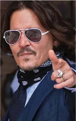  ??  ?? Upbeat: Johnny Depp arriving for the hearing yesterday