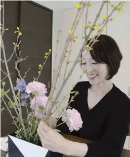  ?? Yomiuri Shimbun photos ?? Clockwise from left:
Kotaro Tabata from Yokosuka, Kanagawa Prefecture, looks through an album as part of research for his autobiogra­phy.
Kumi Nakanishi in Tokyo arranges flowers in her room.