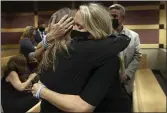  ?? AMY BETH BENNETT — SOUTH FLORIDA SUN SENTINEL ?? Gena Hoyer, right, hugs Debbi Hixon during a court recess Wednesday at the Broward County Courthouse in Fort Lauderdale, Fla. Hoyer’s son, Luke Hoyer, 15, and Hixon’s husband, Christophe­r Hixon, 49, were both killed in the massacre.