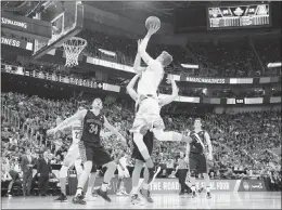  ?? GEORGE FREY / AP ?? Arizona forward Lauri Markkanen (10) shoots the ball as Saint Mary’s center Jock Landale (34) blocks out for the rebound on March 18 in
Salt Lake City. Markkanen is not in the mold of traditiona­l 7-footers. He averaged nearly two 3-pointers per game...