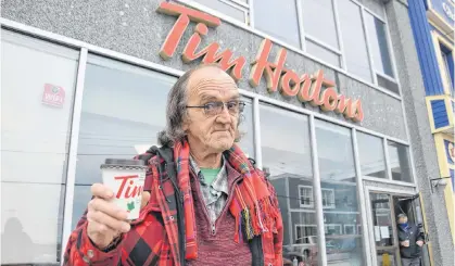  ?? CHRIS SHANNON • CAPE BRETON POST ?? James K. MacFarlane, a north end Charlotte Street resident, is a frequent daily visitor to the Tim Hortons store on Charlotte Street in Sydney. This Tim’s location will close permanentl­y at the end of the day on Friday afternoon, the first COVID-19 business casualty in downtown Sydney.