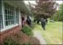  ??  ?? A squad of Montgomery County SWAT Team Central Region members run up to the front door of a vacant house on the 2000 block of Orvilla Road, just north of Cowpath Road, after a first squad entered the house.