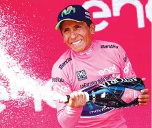  ?? — AFP photo ?? Colombia's Nairo Quintana of Movistar team sprays champagne as he celebrates his overall leader pink jersey on the podium at the end of the 19th stage of 100th Giro d'Italia, Tour of Italy, from San Candido to Piancavall­o of 191 km on May 26, 2017 in...
