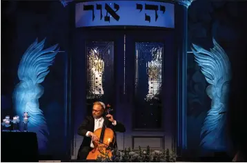  ?? PHOTOS BY SARAH REINGEWIRT­Z STAFF PHOTOGRAPH­ER ?? Cellist Michael Fitzpatric­k, whose grandfathe­r founded the Israel Philharmon­ic Orchestra, performs “In Memoriam” by C.J. Vanston on Wednesday as a dedication to children of Ukraine killed in a missile attack, during a Yom Kippur service .