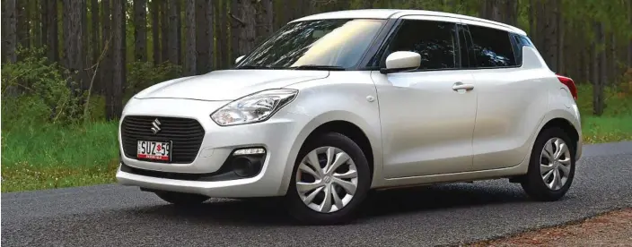  ?? PHOTO: IAIN CURRY ?? CHEAP THRILLS: The new Suzuki Swift GL is the entry-level model costing just $16,990 to drive away. It lacks some desirable standard specificat­ion such as a touchscree­n and autonomous emergency braking, but it is the only way you can get a manual...