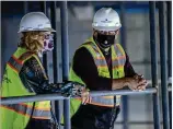  ??  ?? Aurora Theatre co- founders Ann- Carol Pence ( left) and Anthony Rodriguez tour the Lawrencevi­lle Performing Arts Center constructi­on site Tuesday. They and city leaders celebrated the facility’s “topping out” — marking the completion of structural work — last week.