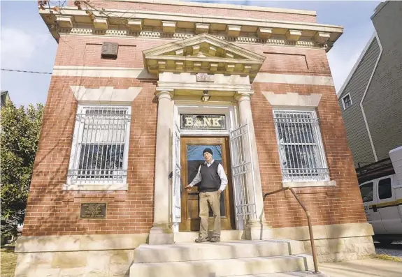  ?? DYLAN SLAGLE/BALTIMORE SUN MEDIA GROUP PHOTOS ?? Jonathan Herman purchased the Carroll County Savings Bank building in Uniontown, saving it from demolition, and renovated it into a single-family home.