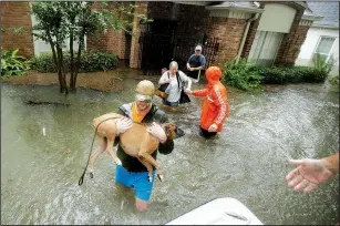  ?? AP/CHARLIE RIEDEL ?? Volunteers help a family get out of their home Monday in a Houston neighborho­od inundated by floodwater­s. Federal Emergency Management Agency officials said Monday that the response to Harvey is “quickly drawing down” its disaster fund of more than $3...