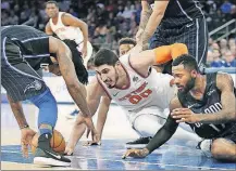  ?? ASSOCIATED PRESS] [KATHY WILLENS/THE ?? Orlando Magic guard Elfrid Payton, left, picks up a loose ball after New York Knicks center Enes Kanter (00) lost it next to Magic forward Jonathon Simmons, right, during the second half Sunday in New York, Sunday.