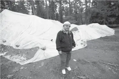  ??  ?? Cathy Blaskow with a pile of 80 tonnes of contaminat­ed soil removed from her family’s Goward Road property. The Blaskows bought the property in 2012 and weren’t aware of any contaminat­ion, she says.